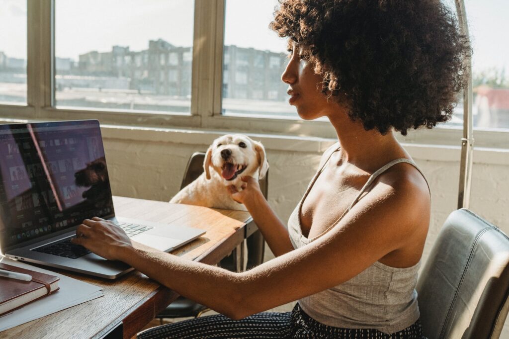pillar blog post featured image of black woman with a laptop and dog
