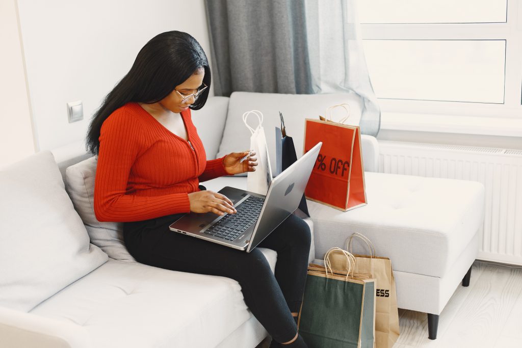 African woman online shopping at home